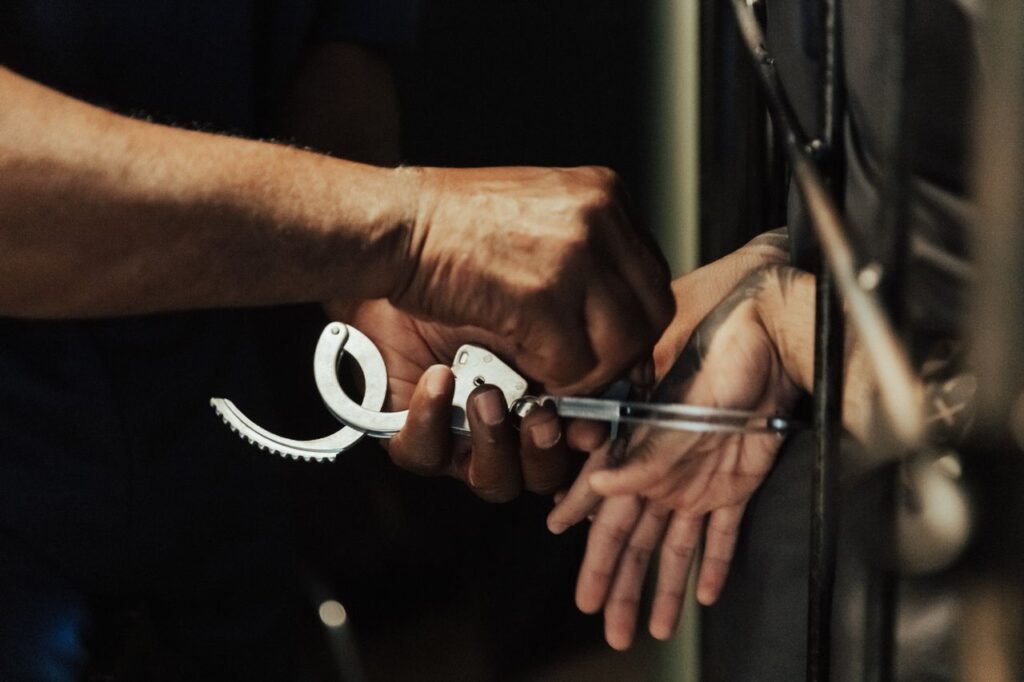 hombre siendo esposado en prision